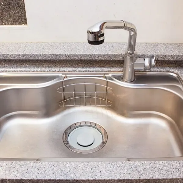 A stainless steel kitchen sink representing expert blocked sink repairs by Drain Medics