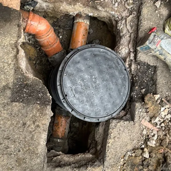 Expert drain excavation and structural sewer repair showing a newly installed inspection chamber by Drain Medics